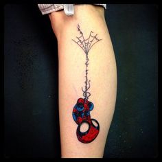 a spiderman tattoo on the leg of a woman's arm with a balloon attached to it