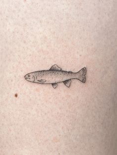 a fish tattoo on the back of a woman's stomach