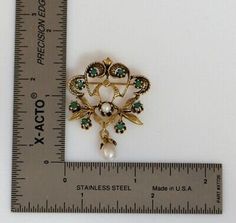 "This is a 14K Yellow Gold Floral Emerald & Pearl set Brooch, 8 Emeralds & Pearl Prong set with Pearl Suspension, 1.5\" height, Circa 1950, weight 6.8 grams Stock # BB95L09 This listing contains photographs of the actual item you will receive. Our items are in excellent condition with little or no signs of wear and many are one of a kind pre-owned estate finds. Please look closely at the pictures in this listing as they are part of the product description. Please read the description, as Antique Jeweled Brooches For Formal Occasions, Heirloom Pendant Brooch For Wedding, Victorian Jeweled Formal Brooches, Heirloom Pendant Brooches For Weddings, Antique Jeweled Brooches For Wedding, Antique Pendant Brooches For Anniversary, Victorian Gold Brooches With Jewels, Victorian Jeweled Brooches For Anniversary, Antique Jeweled Brooches For Anniversary