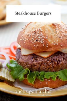 a hamburger on a plate with lettuce and cheese