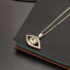 Product Description: Materials: 18k Gold Plated, Cubic Zirconia, Crystals Chain Length: 40+5cm / 16+2inch Pendant Size: 15mm Package Contains: 1x Necklace Beautiful and fashionable design, buy it with confidence! Pendant Shape Evil Eye Length (inches) 16 Fine or Fashion Fashion Necklace Type Pendant Necklaces Color Gold Cut Grade Excellent Material Metal Main Stone Color Blue Gender Female Item Type Necklaces Metal Titanium Secondary Stone Cubic Zirconia Metals Type gold plated Cubic Zirconia Necklace With Gold Chain For Gift, Gift Cubic Zirconia Necklace With Gold Chain, Eye Pendant Necklace, Evil Eye Design, Blue Evil Eye, Crystal Chain, Eye Pendant, Trendy Necklaces, Evil Eye Pendant