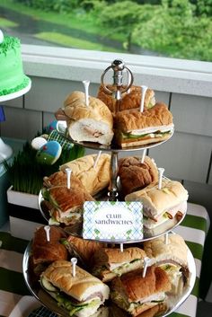 a tiered tray with sandwiches on it