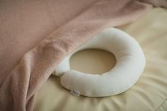 a white pillow sitting on top of a bed