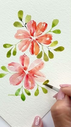 someone is painting flowers with watercolors on paper