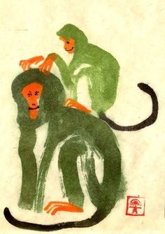 two monkeys sitting on top of each other