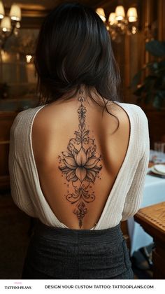 a woman with a flower tattoo on her back