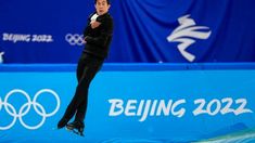 a man is in the air with his feet up while performing an artistic trick on ice skates