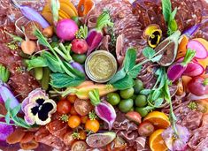 an arrangement of fruits and vegetables on a platter