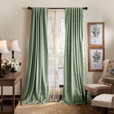 a living room filled with furniture and a window covered in green drapes next to a lamp