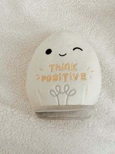 a white pillow with the words think positive written on it