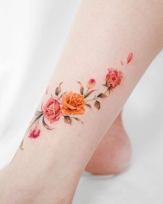 an orange rose tattoo on the left leg