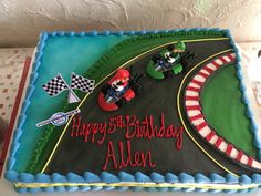 a birthday cake that is shaped like a race track