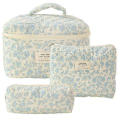 three pieces of blue and white floral print cosmetic bag with zipper closures on the side