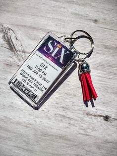 a key chain with a ticket attached to it