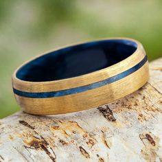 a wooden ring sitting on top of a tree branch