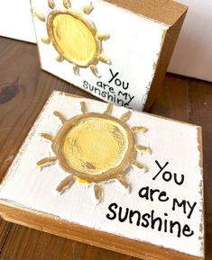 So cute! "You are my sunshine..." This wood block is hand painted in a soft palette with white background and yellow sun. It includes black lettering, gold embellishments, and thick gold sides. Size is 3x5 inches. Artist signature and company name are included on the back. Because each design is individually drawn and textured, each block is unique and will vary slightly. You Are My Sunshine Painted Rock, You Are My Sunshine Tumbler, You Are My Sunshine Wood Cut Out, You Are My Sunshine Picture Frame, You Are My Sunshine Wood Sign, Yellow Sun, Gold Embellishment, Artist Signatures, You Are My Sunshine