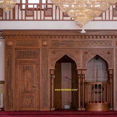 an ornate room with chandelier and wooden doors