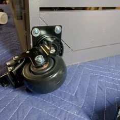 a metal ball on top of a blue bed