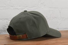 Be effortlessly cool with the Jade Canvas Hat. Made of durable canvas, this hat features a faux leather 'sota' patch and an adjustable strap for the perfect fit. Perfect for any adventure and guaranteed to elevate your style game. - 100% Polyester - One size - Spot clean recommended - Designed in Minnesota - Imported Retail: $30 Canvas Hat, Area Codes, Corporate Gifts, Summer Collection, Minnesota, Olive Green, Jade, Adjustable Straps, Shopping Outfit