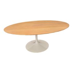 an oval wooden table with white base