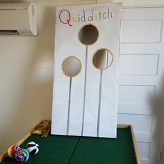 a board game sitting on top of a green table next to a white door with two circles