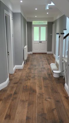 an empty room with wood floors and white trim