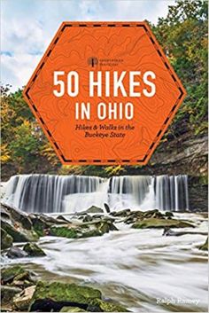 an orange sign that says 50 hikes in ohio on the side of a waterfall