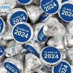 silver foiled hershey kisses with class of 202 stickers on them in blue and white