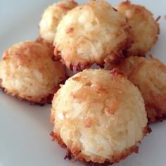 some food is on a white plate and it looks like they are made from coconut