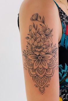 a woman with a flower tattoo on her arm