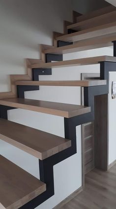 the stairs are made of wood and have black painted treads on each one side