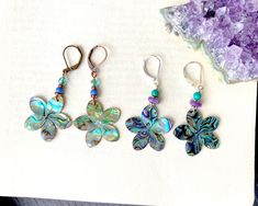 "(listing is for 1 pair, choose your favorite!) Eye-catching iridescent abalone charms, swimming with green and blue, purple, violet and copper, the colors shifting which each movement. There are two styles, choose which one you like.  Especially perfect for summer or fall! Size: 2\" long by 1\" wide  (I do have several more pairs of these flowers in stock, so if one sells, just hit the \"notify me when it's back\" button Style 1: are paired with turquoise green 4 mm Swarovski crystal beads, cop Iridescent Adjustable Pierced Earrings, Iridescent Bohemian Earrings As Gift, Iridescent Bohemian Earrings For Gifts, Nickel-free Abalone Shell Earrings For Gift, Handmade Iridescent Mother Of Pearl Earrings, Nickel Free Iridescent Mother Of Pearl Earrings, Nickel-free Iridescent Mother Of Pearl Earrings, Iridescent Nickel-free Mother Of Pearl Earrings, Iridescent Mother Of Pearl Earrings