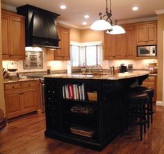 a large kitchen with an island in the middle