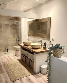 a bathroom with two sinks and a large mirror on the wall next to a bathtub