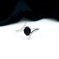 Product Details The beautiful oval-cut Black Onyx in a prong setting is the centerpiece of this gold engagement ring. The bypass shank is adorned with sparkling pave-set Diamond that enhances the stunning black gemstone. Product Information SKU SHP-RINGS082215314 Weight 1.76 gm (Approximate) BLACK ONYX INFORMATION No.of Stones 1 Pieces Total Weight 1.10 Carat (Approximate) Dimension(approx) Oval-6X8 mm-1 Pcs Color Black Cut Brilliant Shape Oval Setting Type Prong-Setting Quality Grade AAA DIAMOND INFORMATION No.of Stones 32 Pieces Total Weight 0.34 Carat (Approximate) Dimension(approx) Round-0.90X0.90 mm-2 PcsRound-1.10X1.10 mm-16 PcsRound-1.20X1.20 mm-12 PcsRound-1X1 mm-2 Pcs Color HI Cut Brilliant Shape Round Setting Type Prong-Setting Quality Grade SI View More Product Parent Collection Formal Black Sapphire Ring With Accent Stones, Formal Black Oval Rings, Black Oval Rings For Promise, Black Oval Diamond Ring For Anniversary, Elegant Black Sapphire Ring With Accent Stones, Oval Black Rings For Promise, Formal Black Oval Ring, Black Oval Diamond Wedding Ring, Elegant Oval Bypass Ring For Formal Occasions