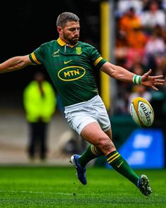 a rugby player is running with the ball