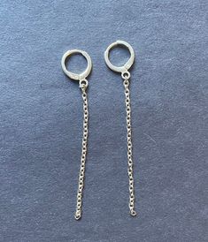 These are a pair of earrings that I make myself using silver-colored chains and mini hoops! The drop-down chain measures 2 inches in length, but can be customized to any length! If you would like a different measurement please leave it in the notes box when placing the order or message me directly! Please message me with any questions or if you would like any additional customizations! Dainty Sterling Silver Chain Earrings, Trendy Silver Hoop Earrings With Adjustable Chain, Silver Dangle Threader Earrings, Silver Dangle Earrings With Cable Chain, Silver Chain Hoop Earrings As Gift, Minimalist Silver Chain Dangle Earrings, Simple Silver Chain Jewelry, Metal Dangle Earrings With Cable Chain Detail, Dangle Chain Hoop Earrings As Gift