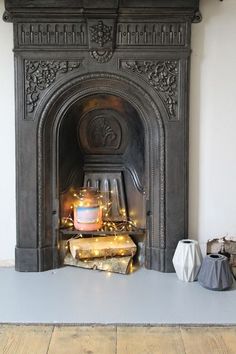 a fireplace with a lit candle on top of it