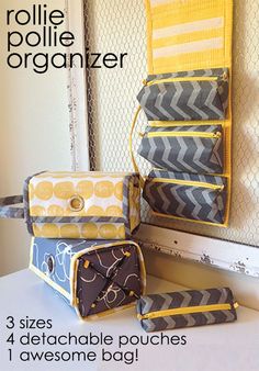 three bags sitting next to each other on top of a white table with the words rollie organizer