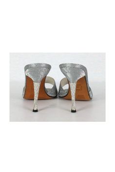 Add a pop of shimmer to any evening look with these statement pumps. Silver glitter roses adorn its fabric and a bedazzled heel adds all the glitz you need. They look great paired with a LBD. Size 8 M Fabric upper, leather lining & sole Slip on Silver glitter roses on fabric Bedazzled heel Light marks on lining Missing some gems stones on heel Some outsole wear Heel height 4.5" Glamorous Synthetic Heels For Gala, Silver Heels With Padded Heel, Holiday Wedding Heels With Glitter Accents, Sparkling Almond Toe Heels For Evening, Glamorous Metallic Silver Heels With 4-inch Heel, Glamorous Metallic Silver Evening Heels, Metallic Silver 4-inch Heels For Formal Occasions, Metallic Silver High Heels For Formal Occasions, Chic Metallic Silver Heels For Evening