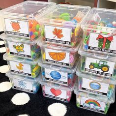 plastic bins filled with different types of toys on a black and white carpeted floor