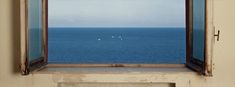 an open window looking out at the ocean