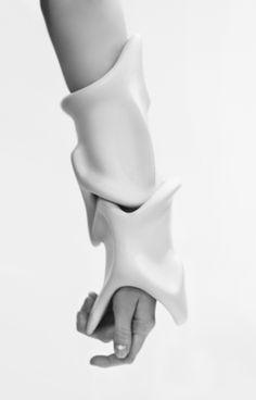 a hand holding an object in the air with it's arm extended up to show its