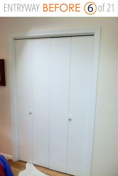 an empty bedroom with white closet doors and wood flooring