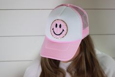 "This hat just screams HAPPY and we are in love. Hat is foam style hat featuring a smiley face patch. Choose your color hat to fit your style. We have several color options to choose from. Hat Details: 100% Polyester foam front, mesh back Structured, five-panel, mid-profile 3 ½\" crown Pre-curved visor with braid detailing Adjustable double snapback closure" Trendy Curved Brim Hat With Smiley Face, Trendy Smiley Face Hat With Curved Brim, Fun 5-panel Hat, One Size Fits Most, Adjustable Smiley Face Cap, Trendy Smiley Face Cap, Cute Snapback Hat With Curved Brim, Fun 5-panel Hat, Summer Baseball Cap With Smiley Face, Adjustable Smiley Face Hat For Spring