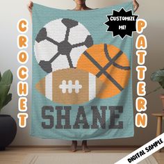 a woman is holding up a blanket with sports balls on it