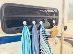 towels hanging on hooks in front of an rv