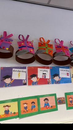 there are many children's crafts on the table with name tags attached to them