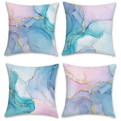 four pillows with blue and pink designs on the front, one has gold foiling