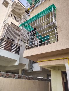 an apartment building with two balconies on the second floor